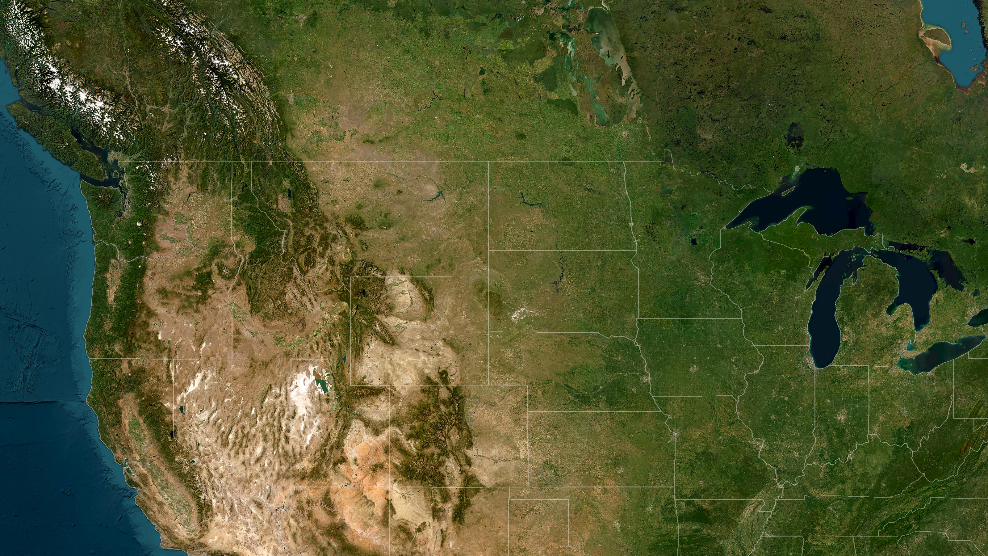 Satellite view of the western and central United States with faint state outlines, centered on the geographic center of the nation in South Dakota